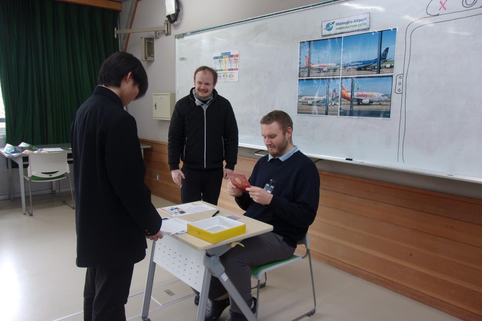 入国審査官に扮するALTの先生